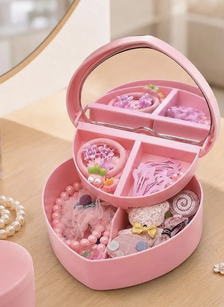 Pink heart jewelry box with a mirror, filled with hair accessories