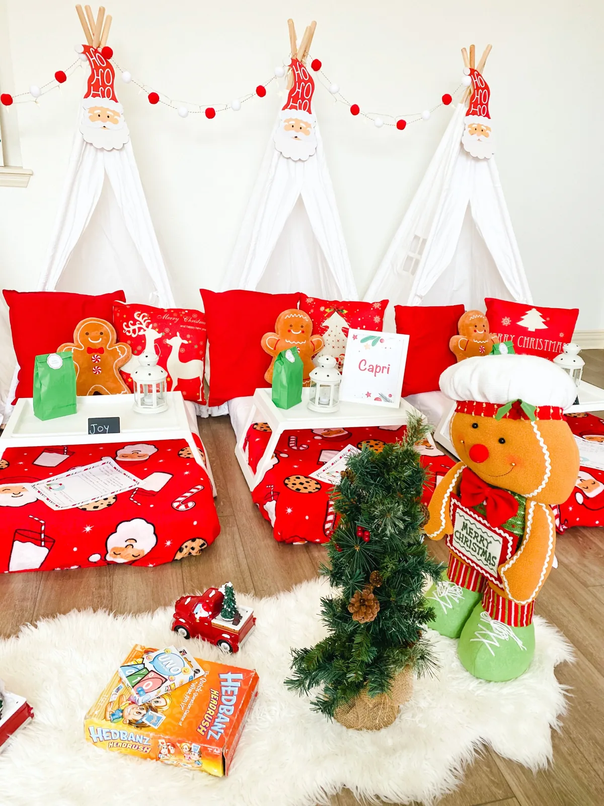 Three Christmas teepees with Santa blankets set up in a kitchen